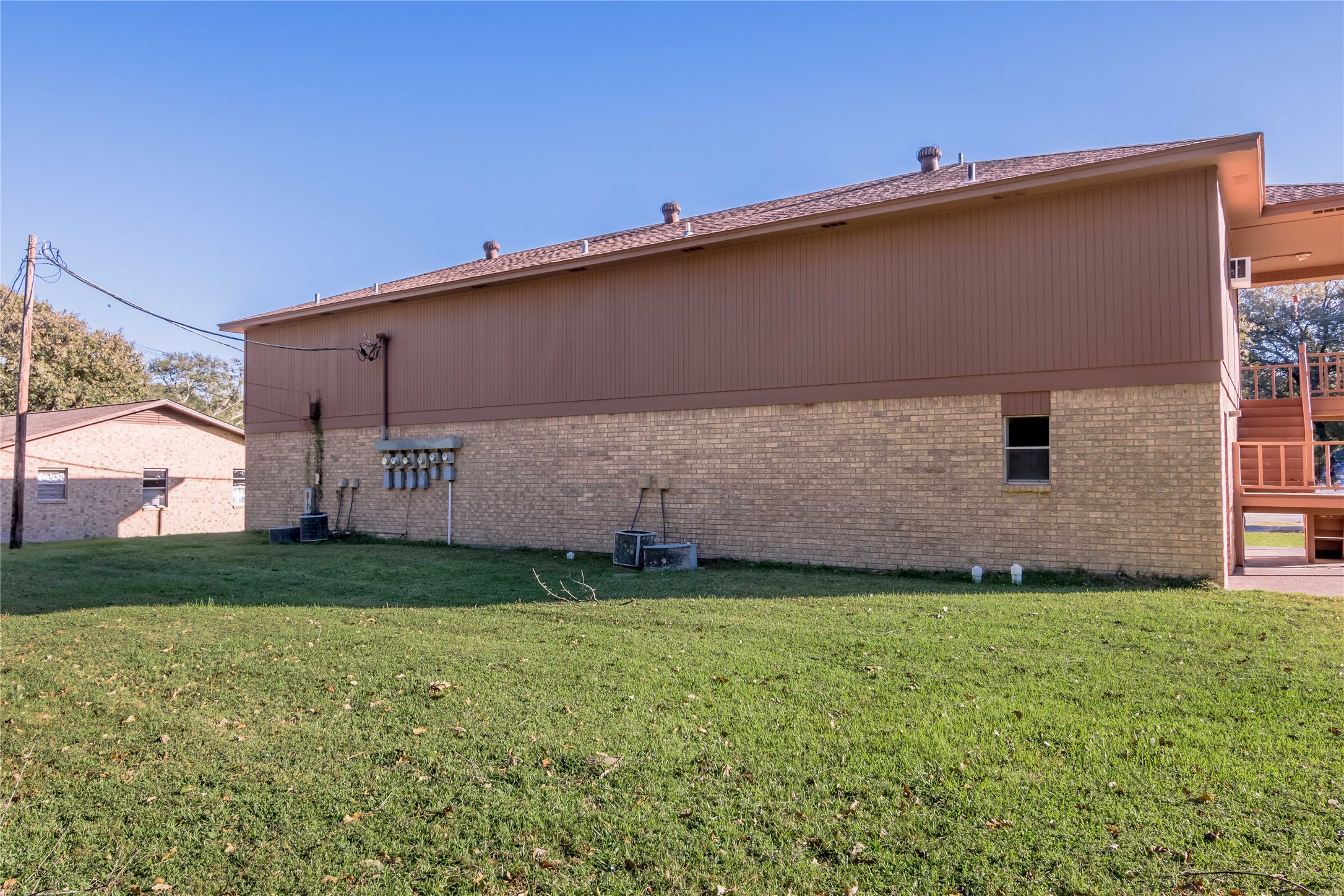 120 McAdams Lane, Unit F Huntsville, TX 77320 - Photo 19 of 21 a front view of a house with a yard