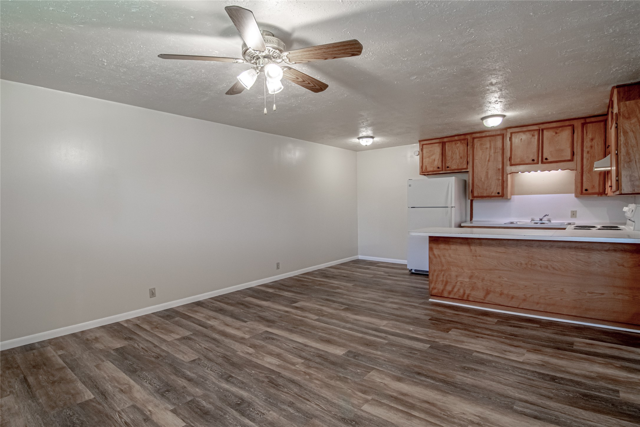 120 McAdams Lane, Unit F Huntsville, TX 77320 - Photo 5 of 21 a view of kitchen with granite countertop cabinets and wooden floor