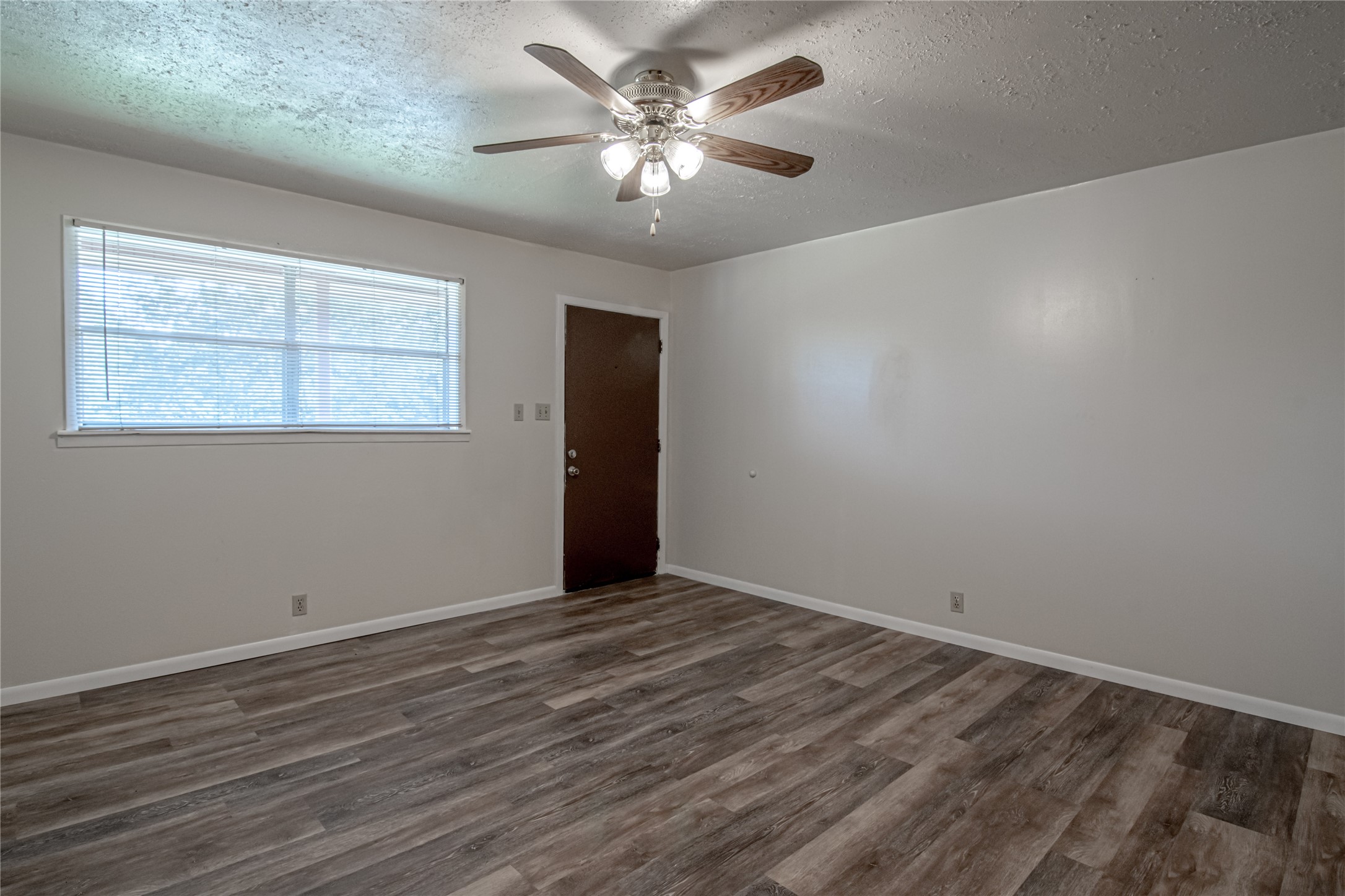 120 McAdams Lane, Unit F Huntsville, TX 77320 - Photo 6 of 21 a view of an empty room with a window