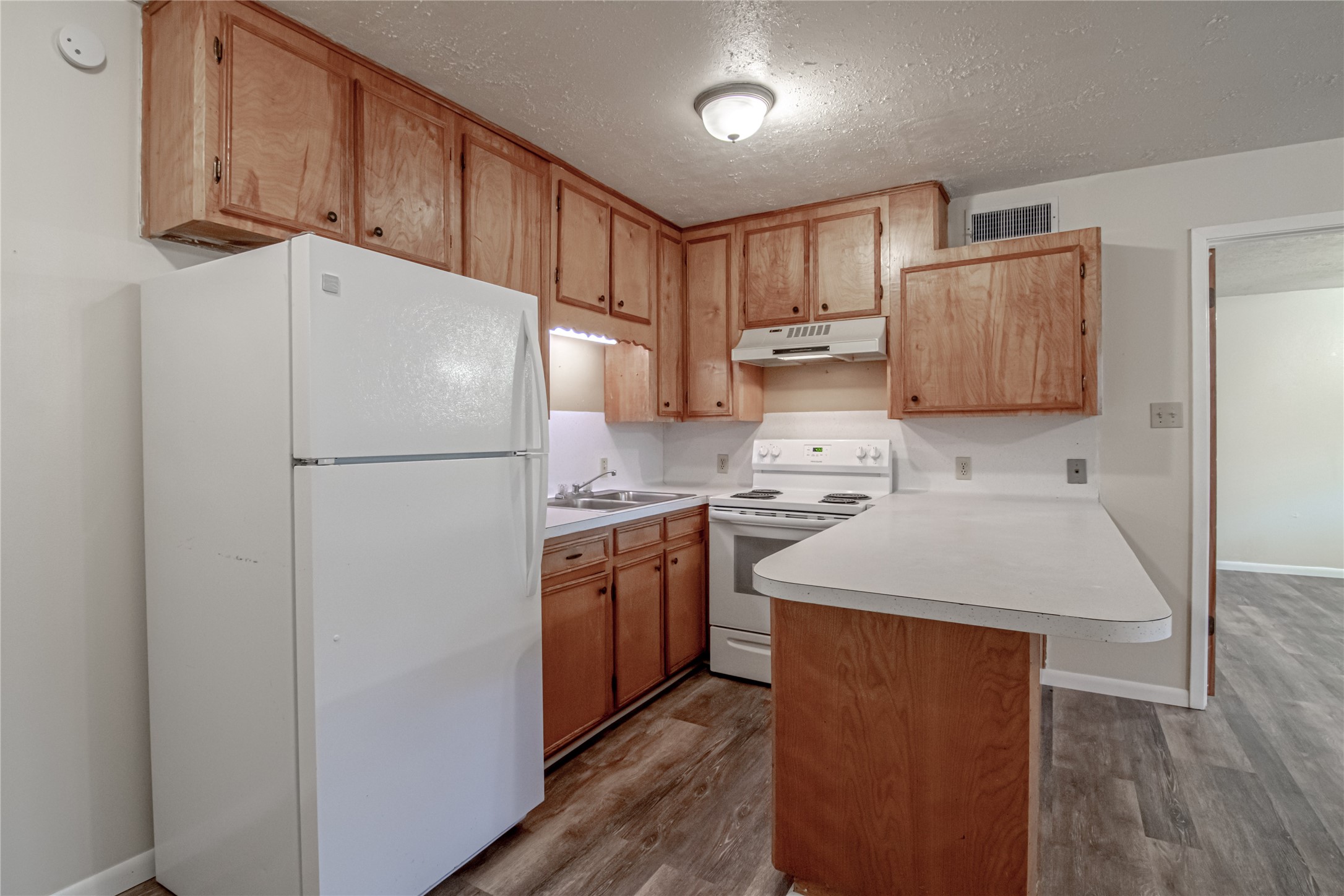 120 McAdams Lane, Unit F Huntsville, TX 77320 - Photo 8 of 21 a kitchen with stainless steel appliances granite countertop a refrigerator a sink and a stove