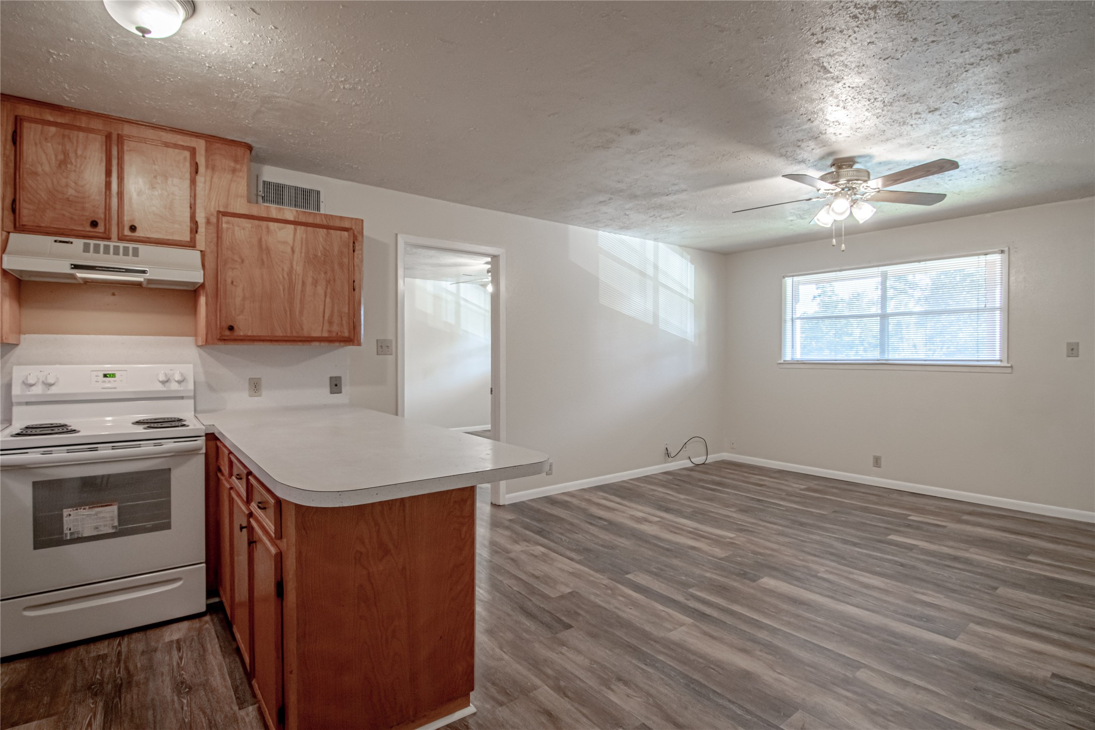 120 McAdams Lane, Unit F Huntsville, TX 77320 - Photo 9 of 21 a kitchen with a sink stove and cabinets