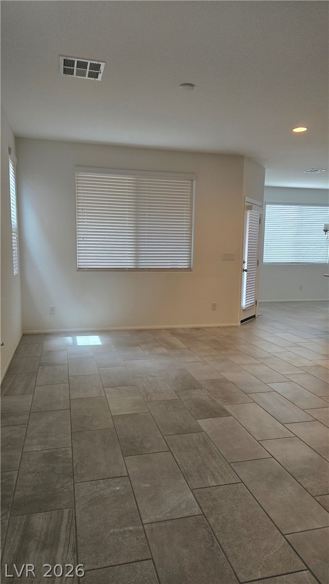 891 Earth Luster Road Las Vegas, NV 89178 - Photo 7 of 20 Gleaming tile flooring runs throughout this open space beneath recessed lighting.