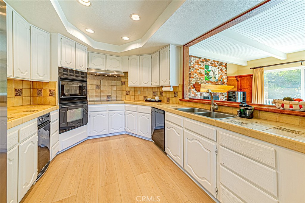 22138 Rim Fire Lane Diamond Bar, CA 91765 - Photo 14 of 61 a kitchen with stainless steel appliances a sink cabinets and a large window