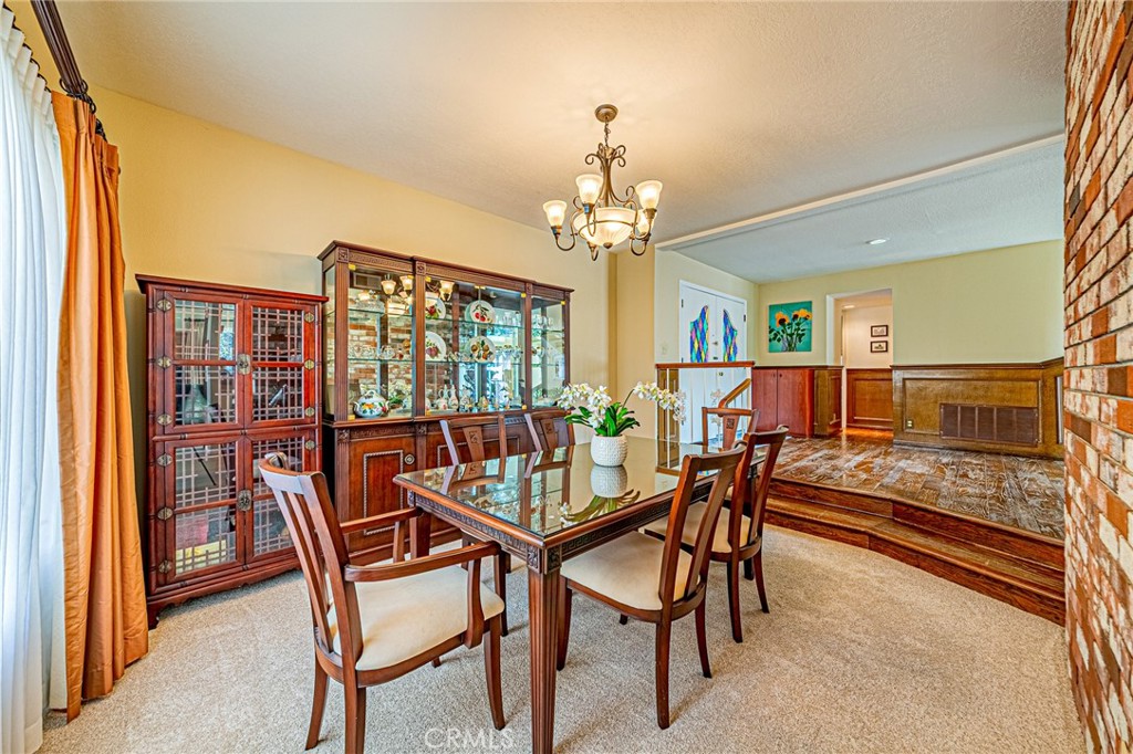 22138 Rim Fire Lane Diamond Bar, CA 91765 - Photo 16 of 61 a dining room with furniture a chandelier and wooden floor