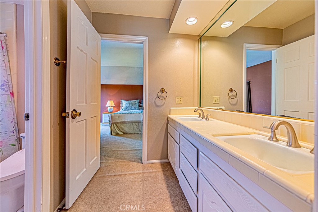 22138 Rim Fire Lane Diamond Bar, CA 91765 - Photo 34 of 61 a en suite bathroom with a sink and mirror with shower