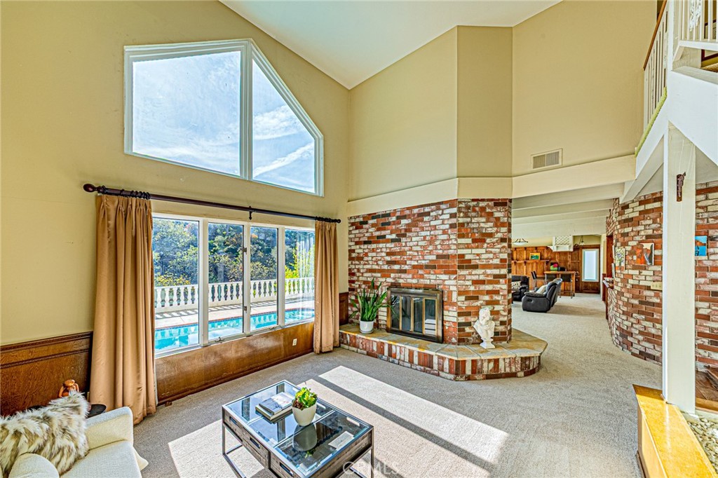 22138 Rim Fire Lane Diamond Bar, CA 91765 - Photo 4 of 61 a living room with fireplace furniture and a floor to ceiling window