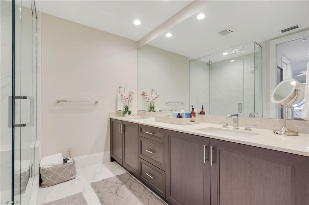 1135 3rd Avenue South, Unit 403 Naples, FL 34102 - Photo 13 of 34 Full bath featuring double vanity, a marble finish shower, light marble finish floors, and recessed lighting