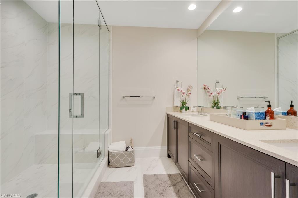1135 3rd Avenue South, Unit 403 Naples, FL 34102 - Photo 14 of 34 Full bathroom featuring double vanity, a marble finish shower, recessed lighting, and light marble finish floors
