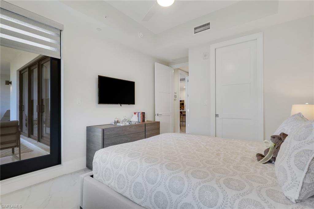 1135 3rd Avenue South, Unit 403 Naples, FL 34102 - Photo 15 of 34 Bedroom featuring marble look tile flooring and ceiling fan