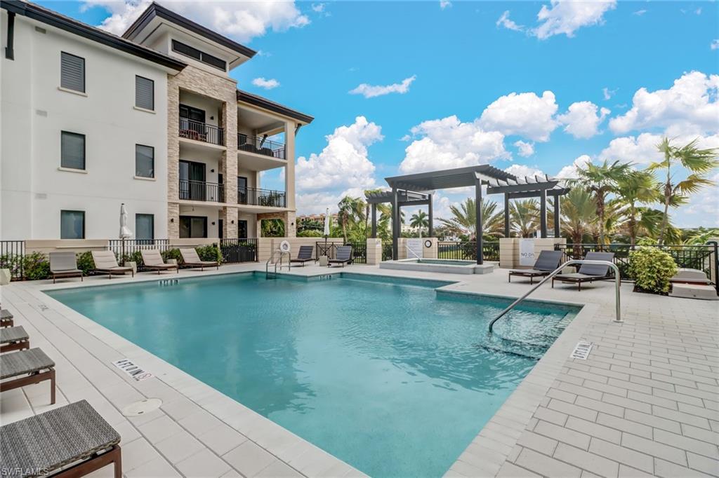 1135 3rd Avenue South, Unit 403 Naples, FL 34102 - Photo 21 of 34 Community pool featuring a patio and a pergola