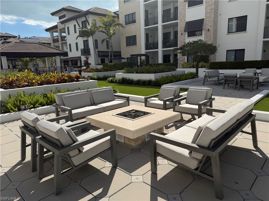 1135 3rd Avenue South, Unit 403 Naples, FL 34102 - Photo 22 of 34 View of patio featuring an outdoor living space with a fire pit