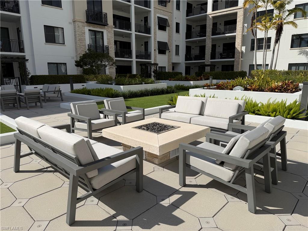 1135 3rd Avenue South, Unit 403 Naples, FL 34102 - Photo 23 of 34 View of patio / terrace featuring an outdoor living space with a fire pit
