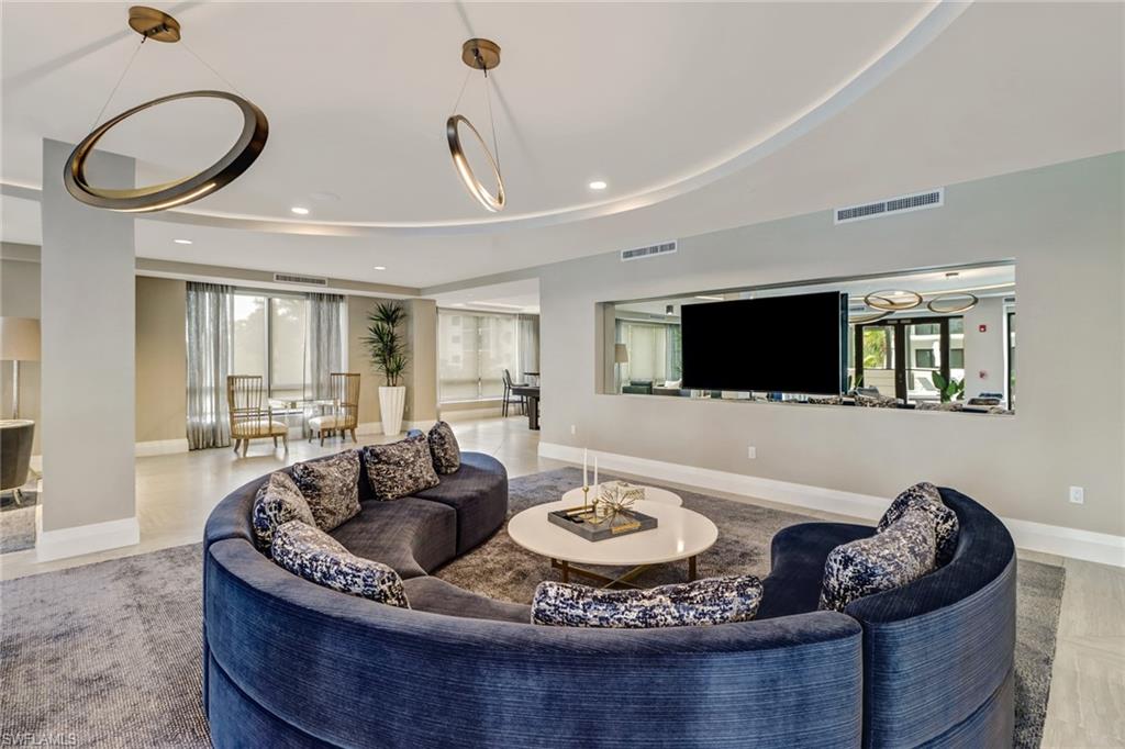 1135 3rd Avenue South, Unit 403 Naples, FL 34102 - Photo 27 of 34 Living room with recessed lighting and a tray ceiling