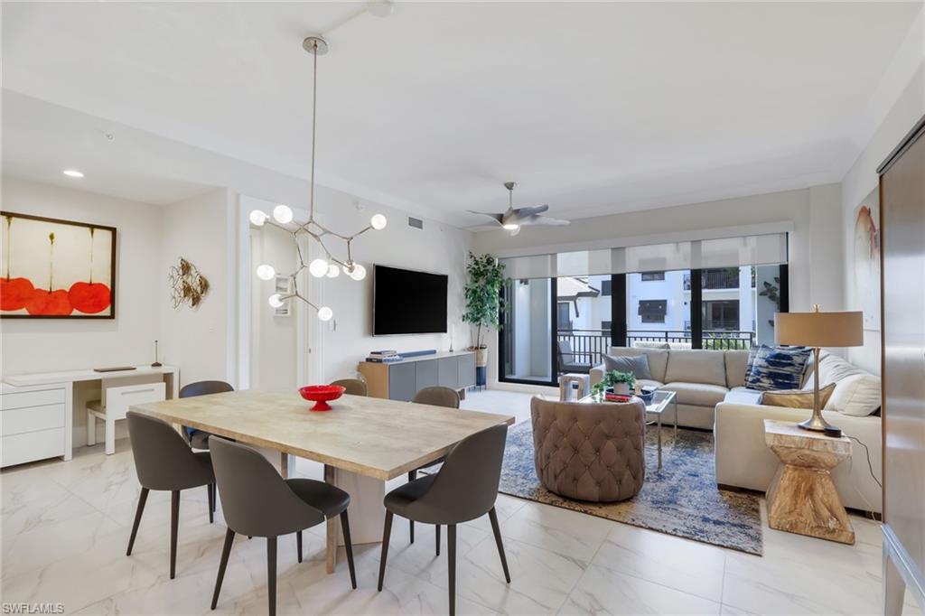1135 3rd Avenue South, Unit 403 Naples, FL 34102 - Photo 7 of 34 Dining space with a chandelier and a ceiling fan