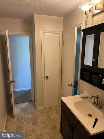 a bathroom with a sink a mirror and a shower
