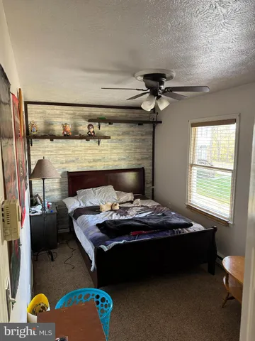 a bedroom with a bed and a fireplace