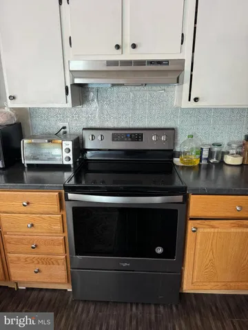 a stove top oven sitting inside of a kitchen