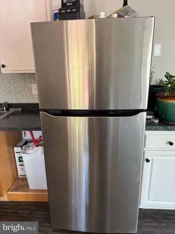 a white refrigerator freezer sitting inside of a kitchen