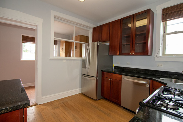 Undisclosed Address Oak Park, IL 60302 - Photo 14 of 18 a kitchen with stainless steel appliances granite countertop a refrigerator and a stove top oven