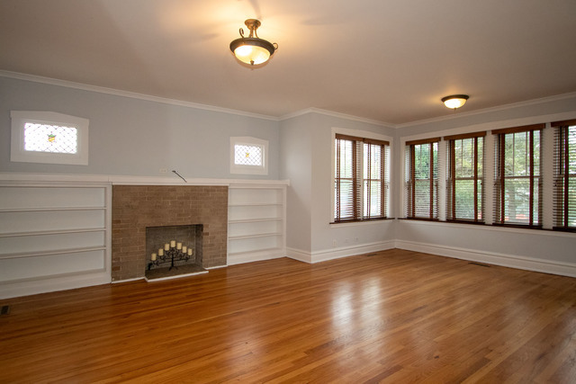 Undisclosed Address Oak Park, IL 60302 - Photo 4 of 18 an empty room with wooden floor fireplace and windows