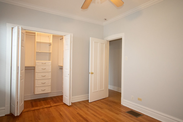 Undisclosed Address Oak Park, IL 60302 - Photo 6 of 18 an empty room with wooden floor closet and windows