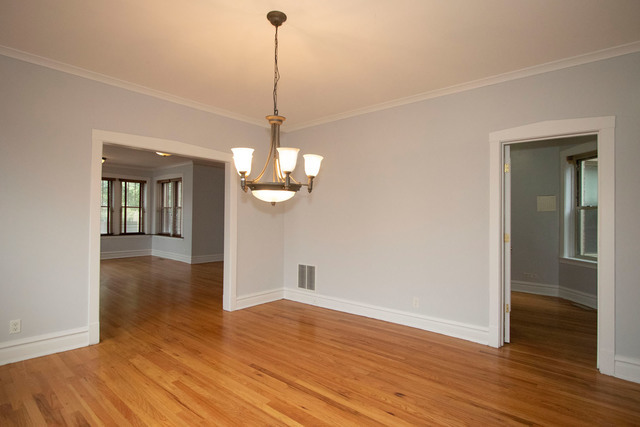 Undisclosed Address Oak Park, IL 60302 - Photo 8 of 18 a view of a livingroom with wooden floor staircase and a kitchen space