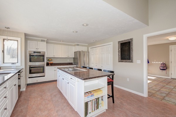 147 Coburn Road Berlin, MA 01503 - Photo 8 of 25 a kitchen with a stove and a refrigerator