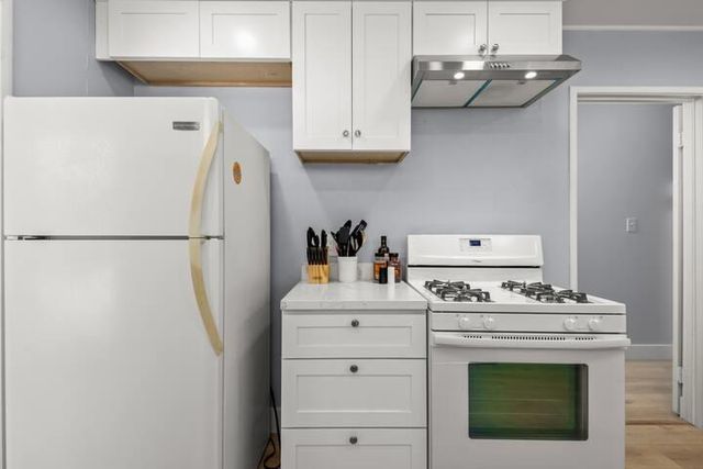 a bedroom with a bed and a lamp