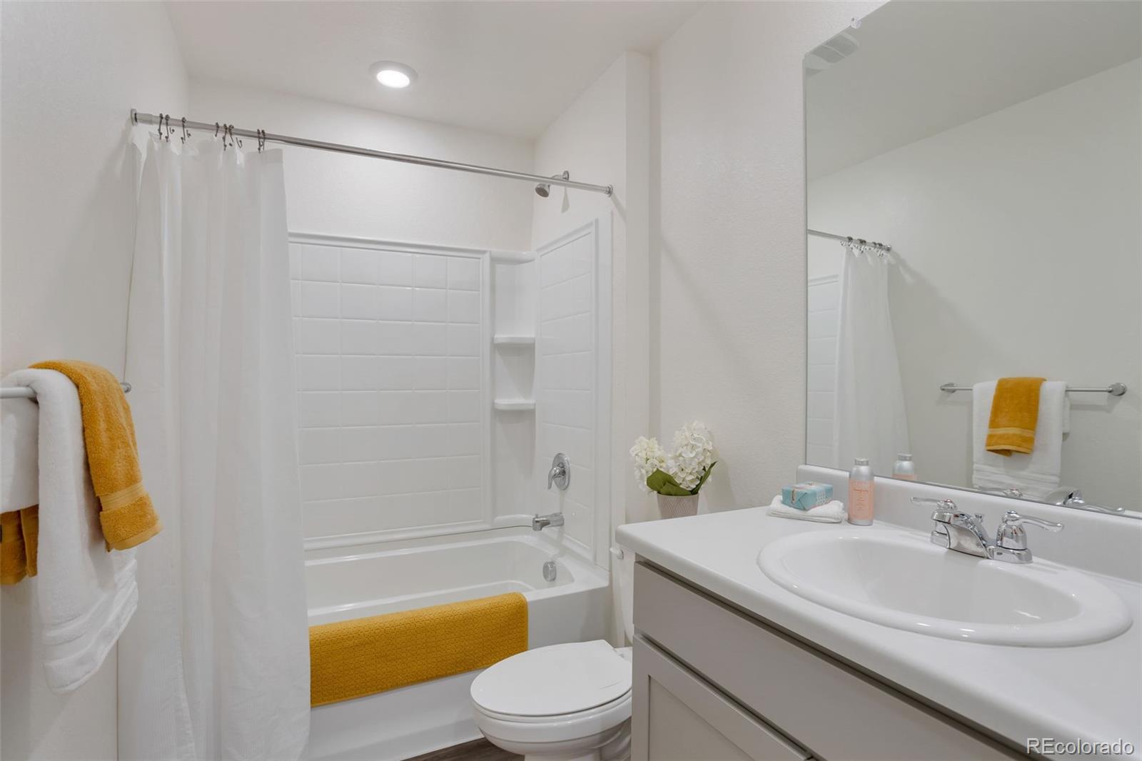 7017 Kali Court Frederick, CO 80530 - Photo 11 of 15 a bathroom with a sink a toilet and shower