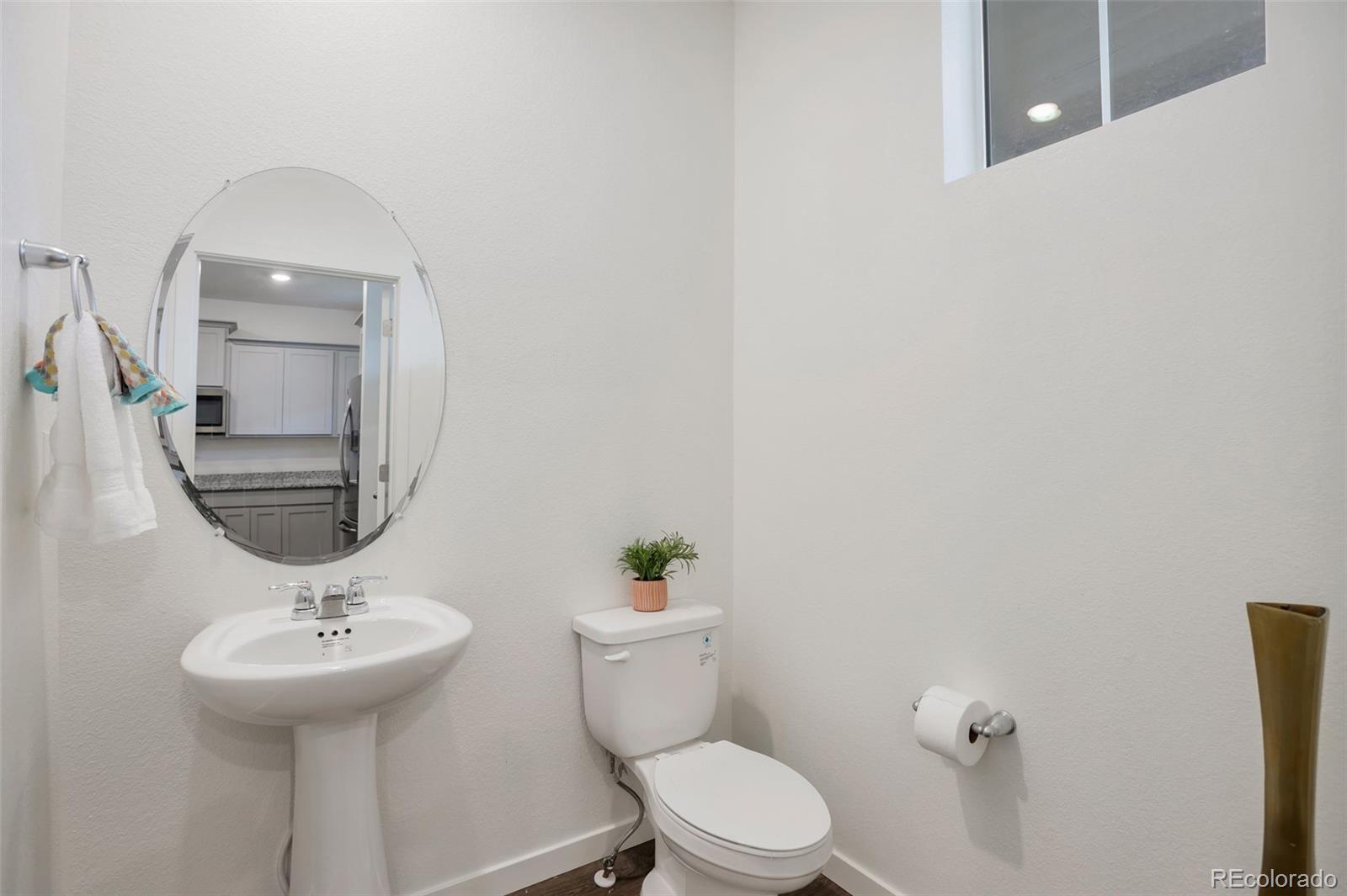 7017 Kali Court Frederick, CO 80530 - Photo 12 of 15 a bathroom with a toilet a sink and mirror