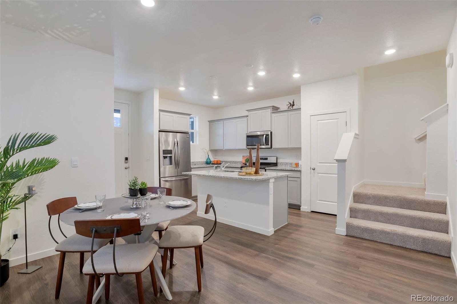 7017 Kali Court Frederick, CO 80530 - Photo 7 of 15 a kitchen with a table and chairs in it
