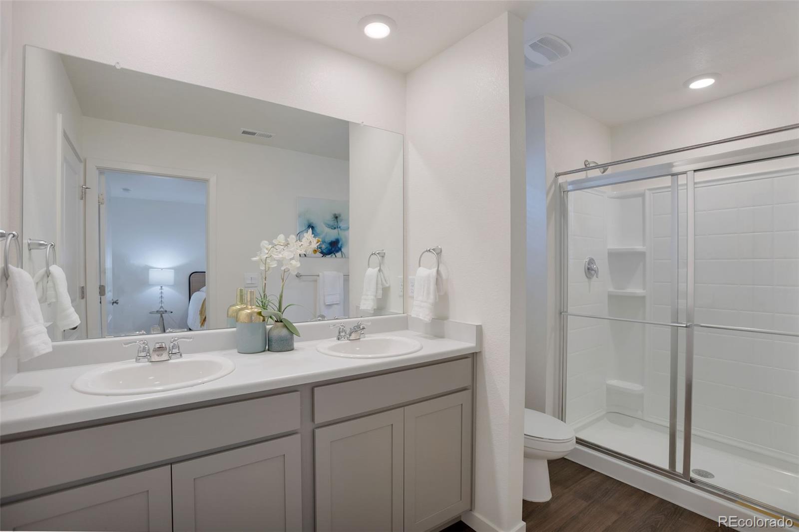 7017 Kali Court Frederick, CO 80530 - Photo 10 of 15 a bathroom with a shower sink vanity mirror and toilet
