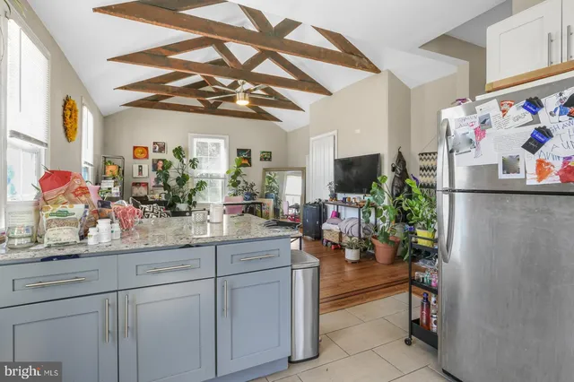 a kitchen with stainless steel appliances granite countertop a stove and white cabinets