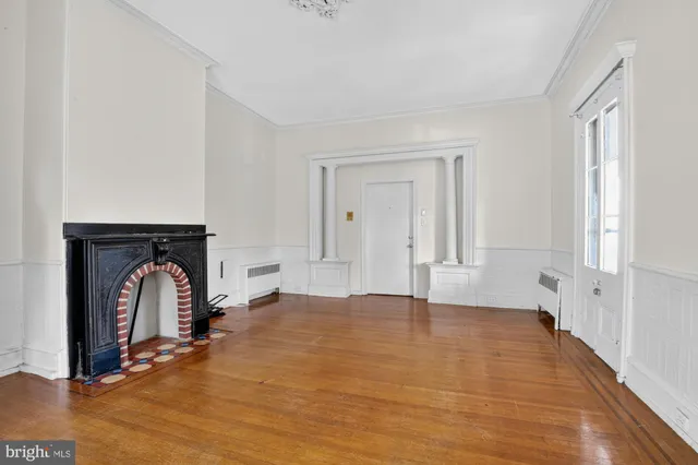 a living room with furniture and a bookshelf