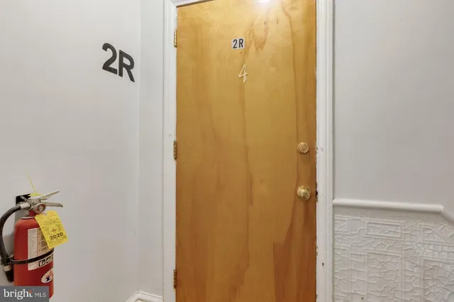 a kitchen with stainless steel appliances granite countertop a white cabinets a stove a sink and a refrigerator