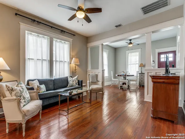 a living room with furniture and a wooden floor