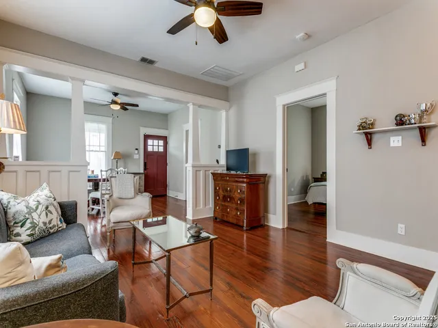a living room with furniture and wooden floor