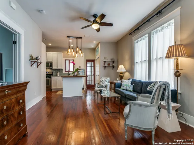 a living room with furniture and kitchen view