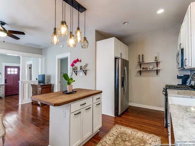 a kitchen with sink stove and cabinets