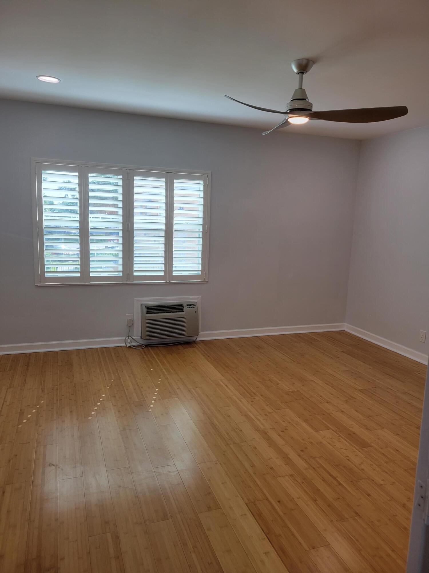 101 South Golfview Road, Unit 11 Lake Worth Beach, FL 33460 - Photo 12 of 28 wooden floor in an empty room with a window