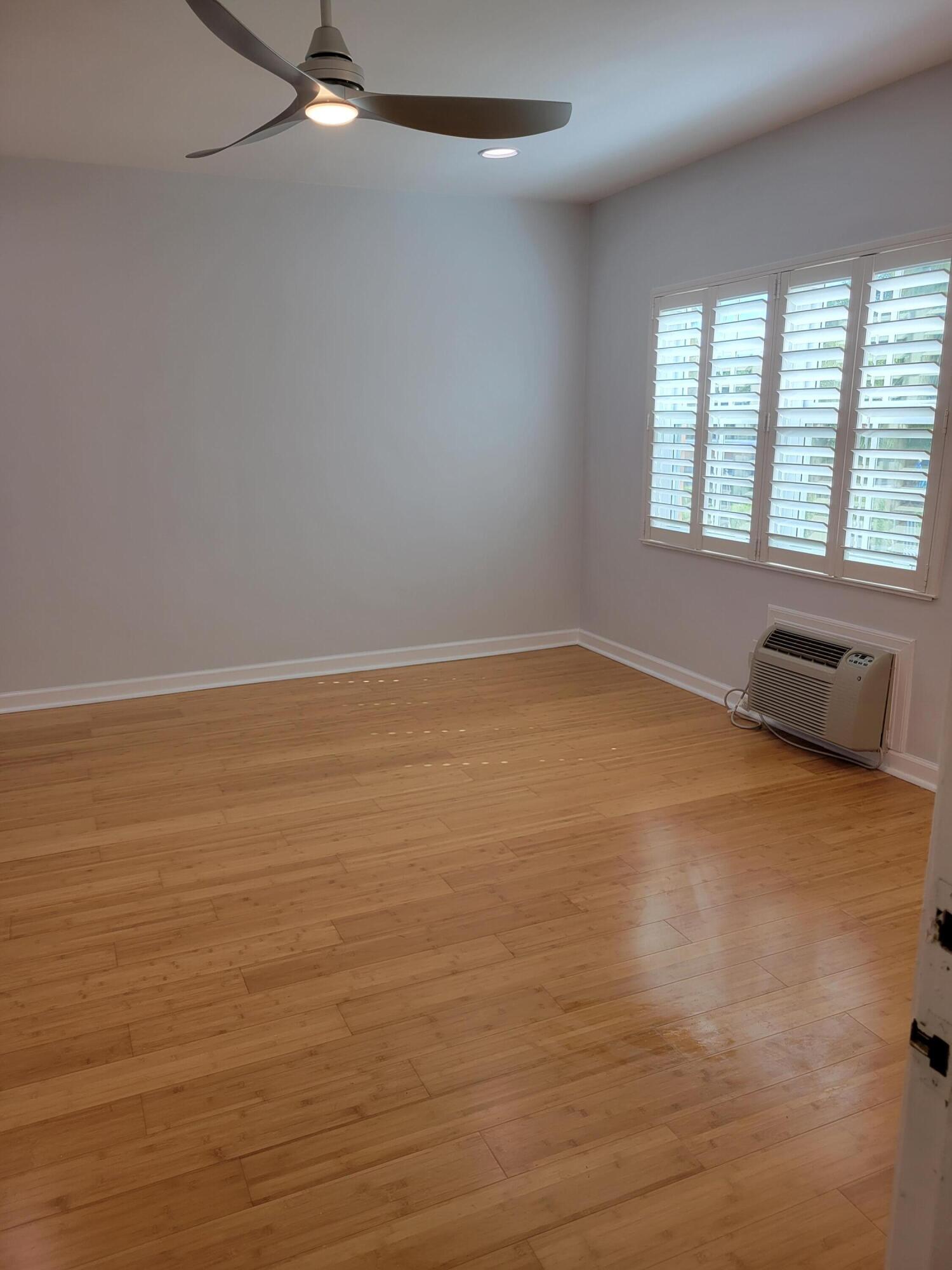 101 South Golfview Road, Unit 11 Lake Worth Beach, FL 33460 - Photo 13 of 28 wooden floor in an empty room with a window
