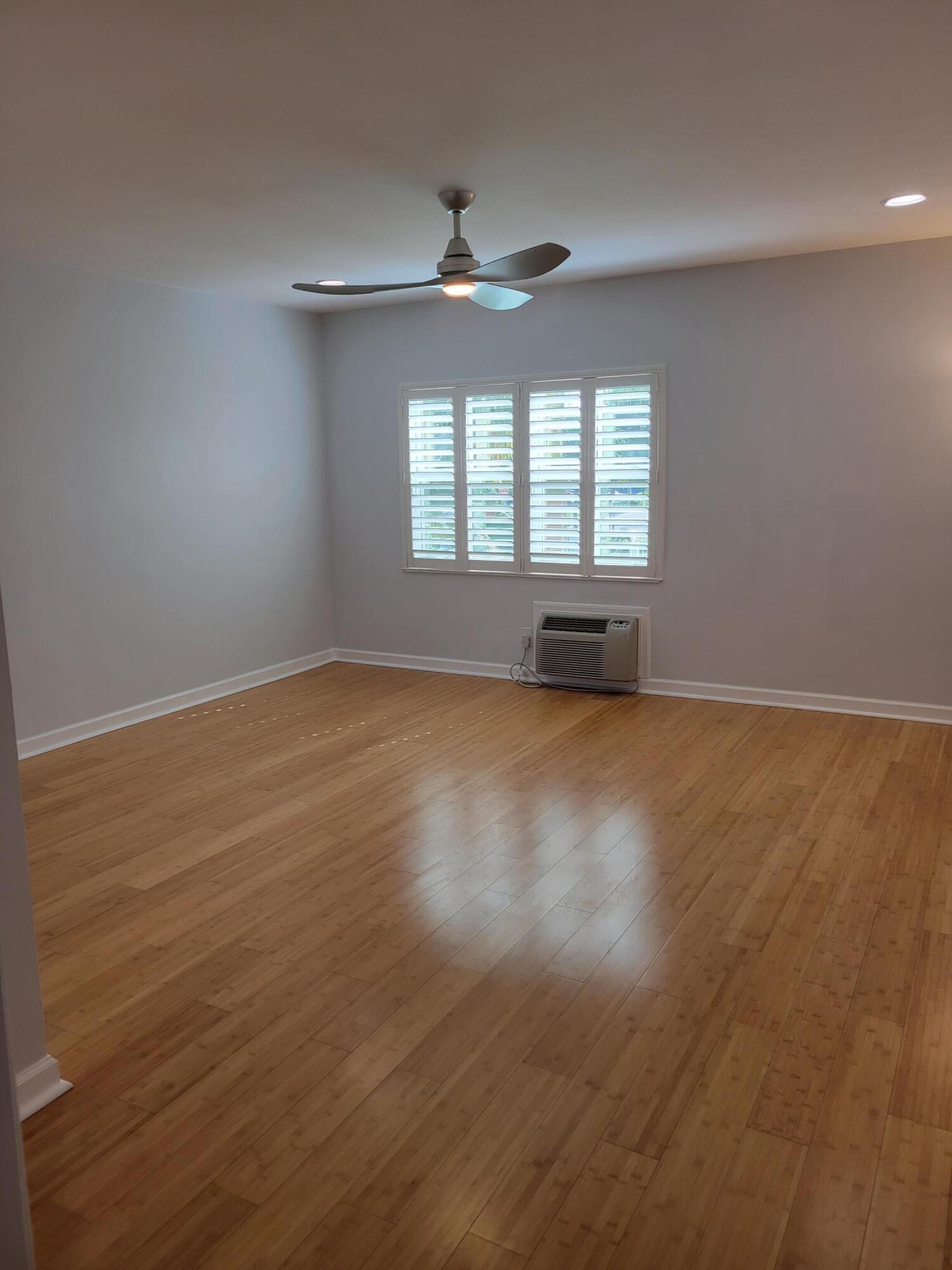 101 South Golfview Road, Unit 11 Lake Worth Beach, FL 33460 - Photo 14 of 28 an empty room with wooden floor and windows