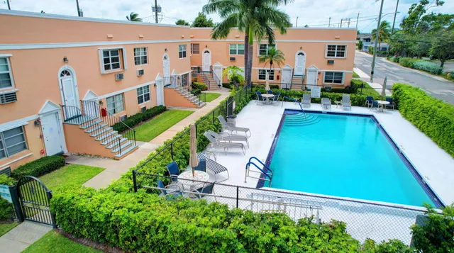 a view of a house with a yard and potted plants