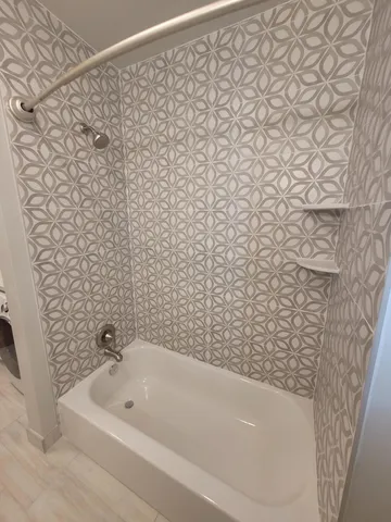 a bathroom with a bathtub and shower