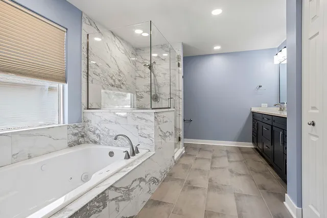 a bathroom with a bathtub and a shower