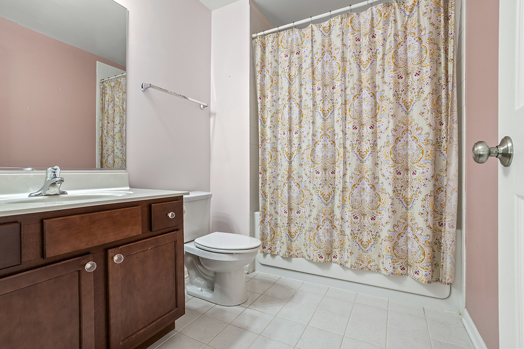 6506 Roth Drive Joliet, IL 60431 - Photo 14 of 24 a bathroom with a toilet a sink and a mirror