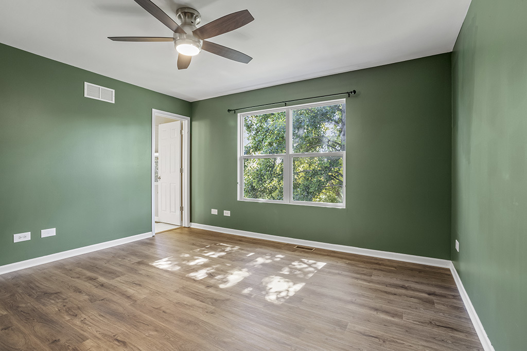 6506 Roth Drive Joliet, IL 60431 - Photo 16 of 24 a view of a big room with windows and chandelier fan
