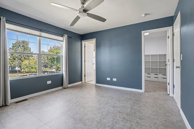 an empty room with windows and closet