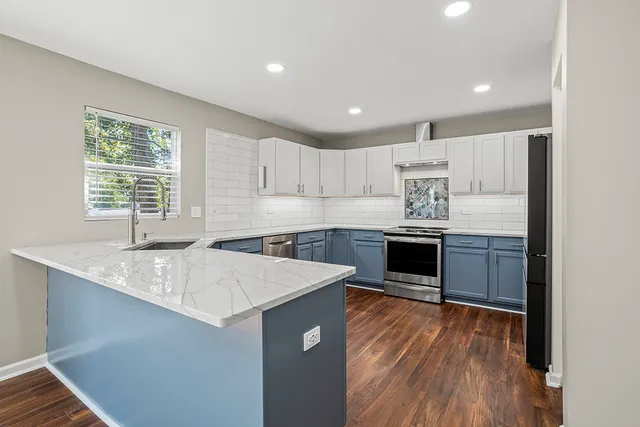 a kitchen with a sink window and cabinets