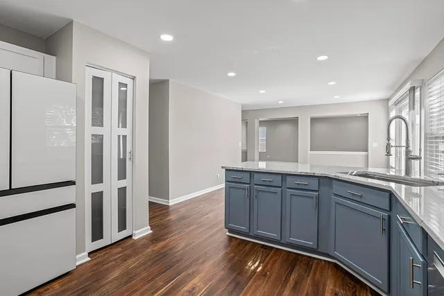 a kitchen with stainless steel appliances granite countertop a refrigerator and a sink